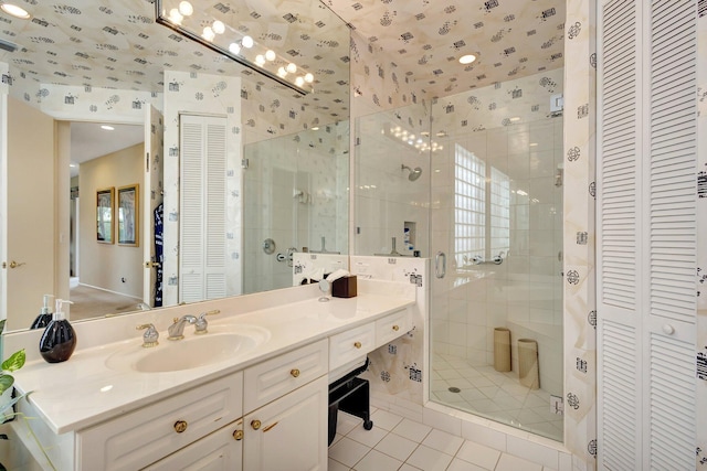 4498 Hazleton Ln, Lake Worth, FL 33449 - full bath featuring a closet, tile patterned flooring, a shower stall, vanity, and wallpapered walls