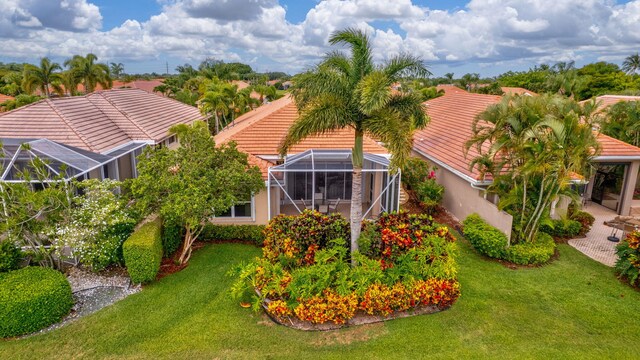 4498 Hazleton Ln, Lake Worth, FL 33449 - back of house with a tiled roof, stucco siding, a yard, and glass enclosure