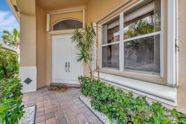 4498 Hazleton Ln, Lake Worth, FL 33449 - view of exterior entry featuring stucco siding