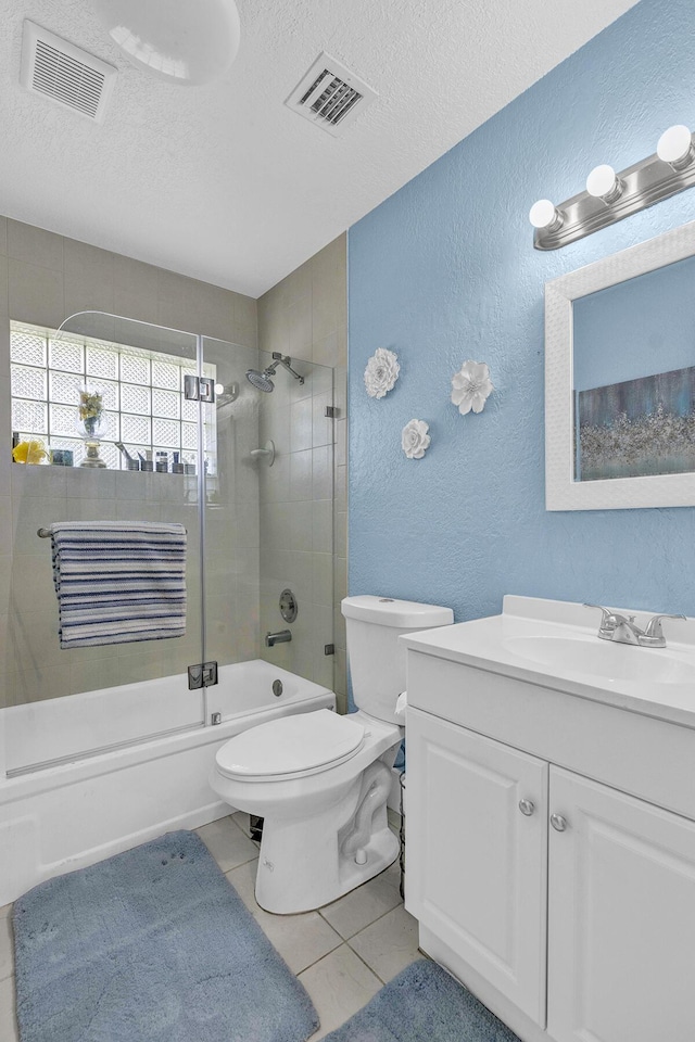6738 Moonlit Dr, Delray Beach, FL 33446 - bathroom with a textured wall, bath / shower combo with glass door, toilet, a textured ceiling, and vanity
