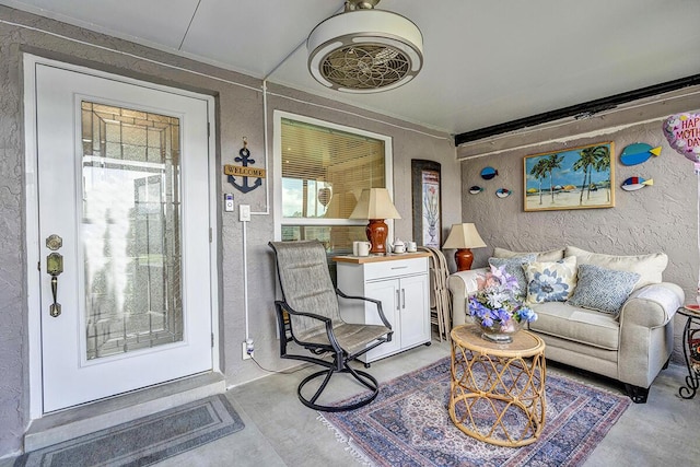6738 Moonlit Dr, Delray Beach, FL 33446 - living room featuring concrete floors and a textured wall