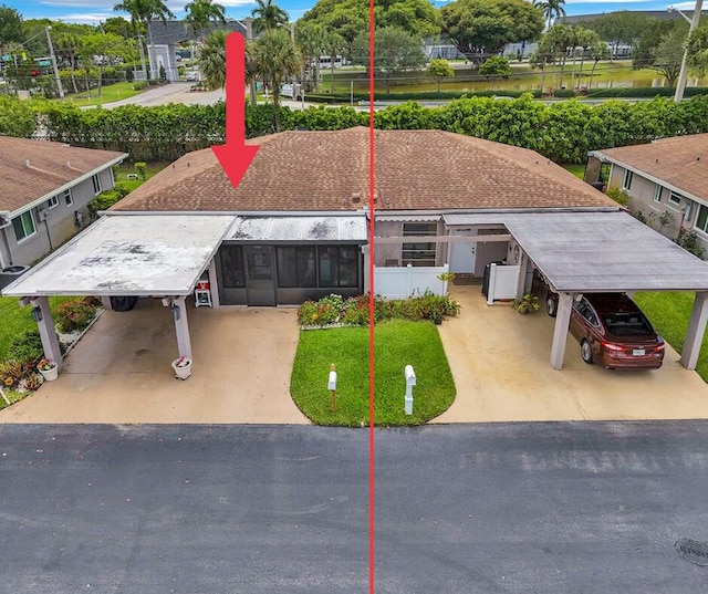 6738 Moonlit Dr, Delray Beach, FL 33446 - view of front of home featuring an attached carport and driveway