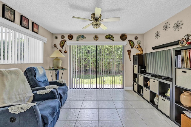 6738 Moonlit Dr, Delray Beach, FL 33446 - living area featuring a ceiling fan, a textured ceiling, and light tile patterned floors