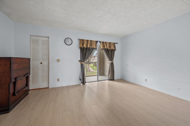 400 Village Green Cir W Unit 205, Palm Springs, FL 33461 - unfurnished living room with wood finished floors and a textured ceiling
