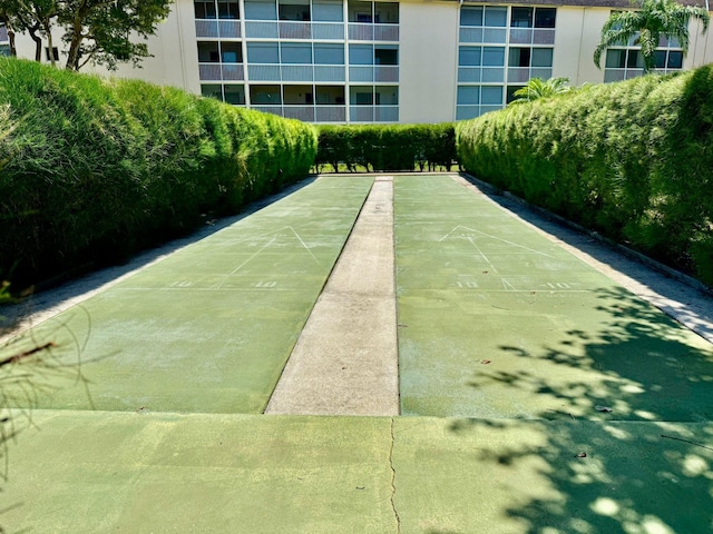 view of property's community featuring shuffleboard