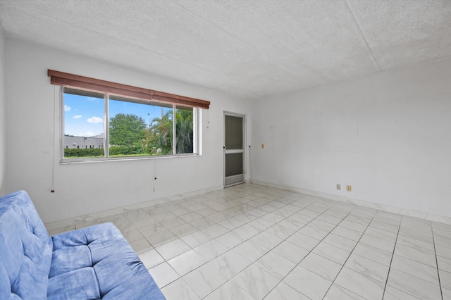 400 Village Green Cir W Unit 205, Palm Springs, FL 33461 - unfurnished living room with a textured ceiling