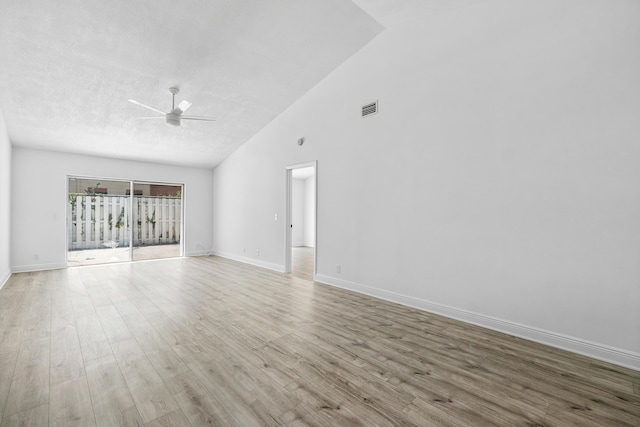unfurnished room with ceiling fan, wood finished floors, baseboards, and high vaulted ceiling