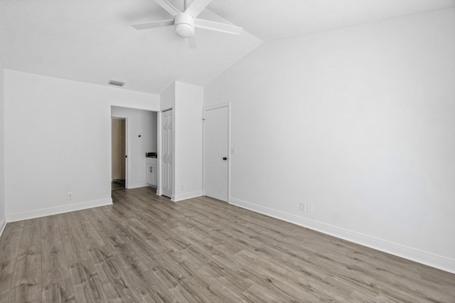 unfurnished bedroom with wood finished floors, lofted ceiling, baseboards, and ceiling fan