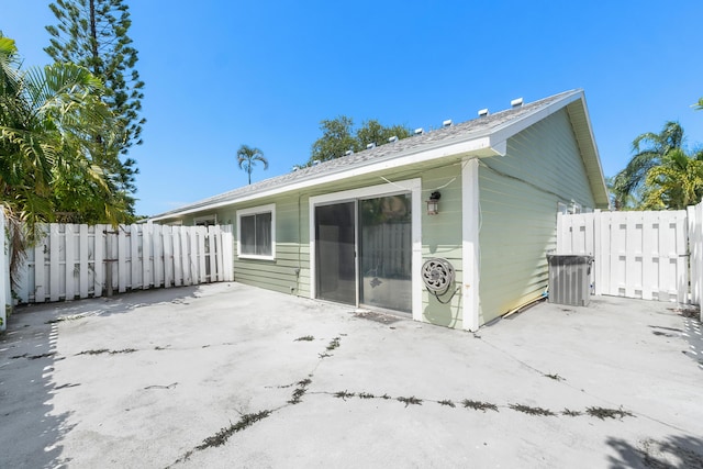 rear view of house with a patio area and fence