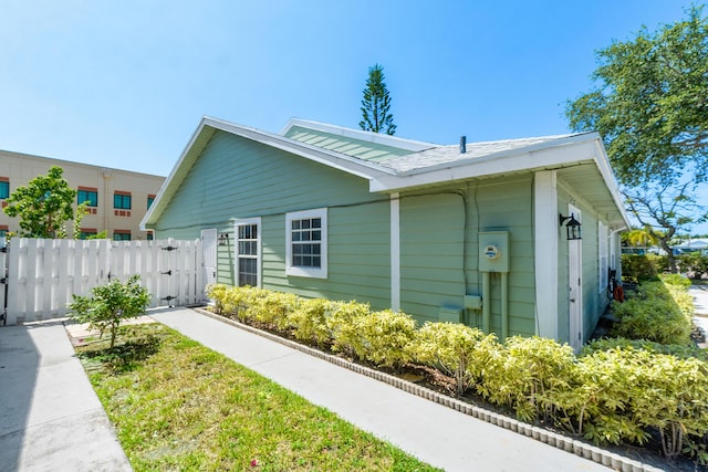 view of home's exterior featuring fence and a gate