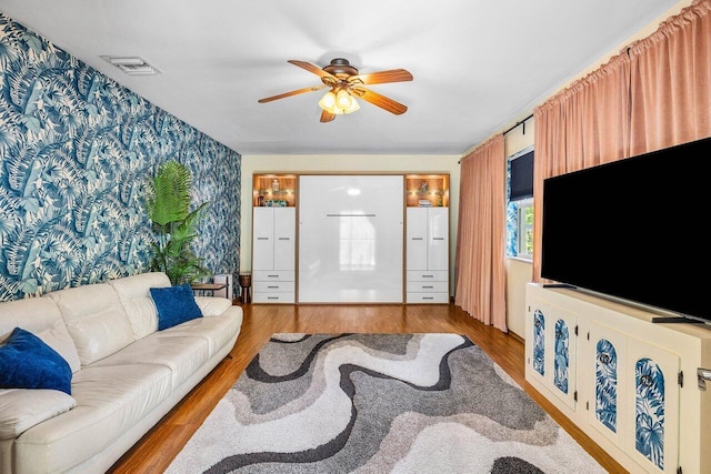 3064 Rostan Ln, Palm Springs, FL 33461 - living area with ceiling fan, wallpapered walls, and wood finished floors