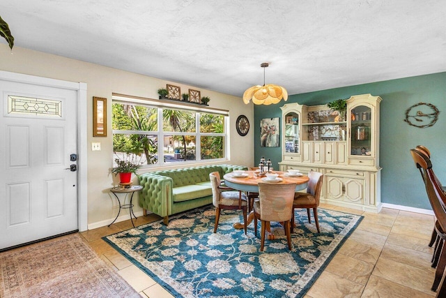 3064 Rostan Ln, Palm Springs, FL 33461 - dining area featuring baseboards, a chandelier, and a textured ceiling