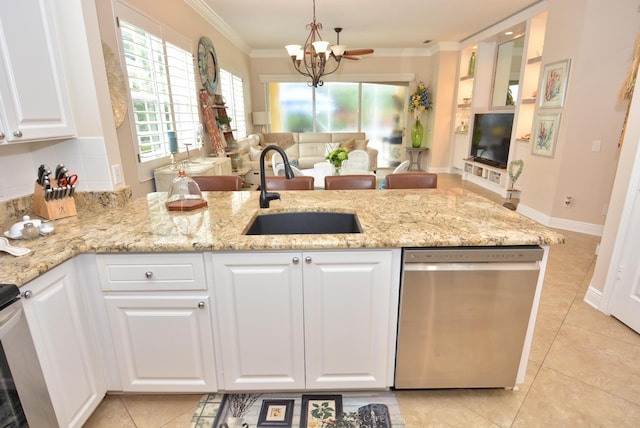 kitchen with stainless steel dishwasher, a sink, white cabinets, and ornamental molding