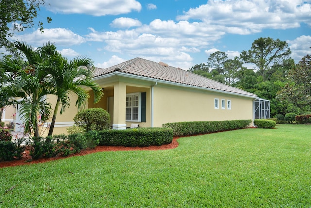 view of property exterior with a lawn, stucco siding, and a tile roof
