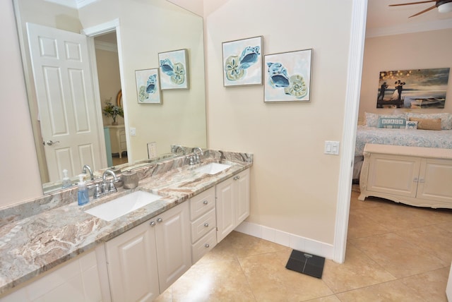 full bathroom with crown molding, baseboards, double vanity, a ceiling fan, and tile patterned floors