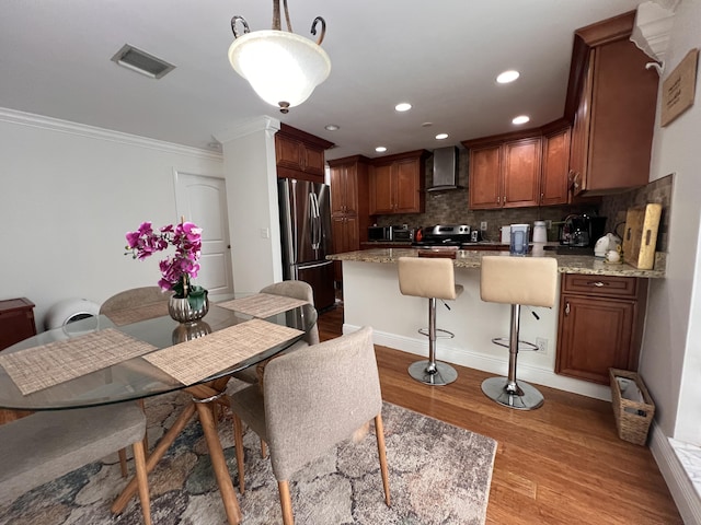 12147 Cuddington Ct, Wellington, FL 33414 - dining room featuring wood finished floors, ornamental molding, recessed lighting, and baseboards