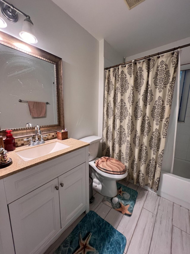12147 Cuddington Ct, Wellington, FL 33414 - full bathroom with toilet, vanity, shower / bath combo, and wood finished floors