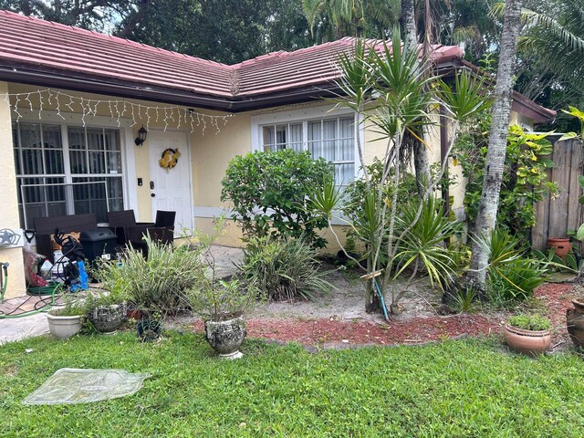 12147 Cuddington Ct, Wellington, FL 33414 - view of front of home featuring a tiled roof and stucco siding