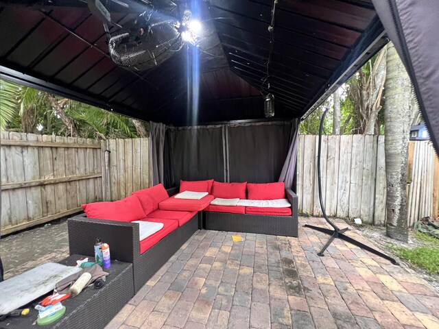 12147 Cuddington Ct, Wellington, FL 33414 - view of patio featuring outdoor lounge area and a fenced backyard