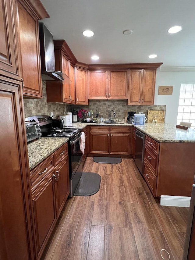 12147 Cuddington Ct, Wellington, FL 33414 - kitchen featuring appliances with stainless steel finishes, wall chimney range hood, a sink, light wood-style floors, and ornamental molding