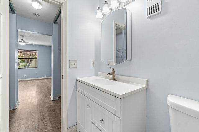 3 Via De Casas Sur Unit 204, Boynton Beach, FL 33426 - half bathroom with wood finished floors, toilet, vanity, and a ceiling fan