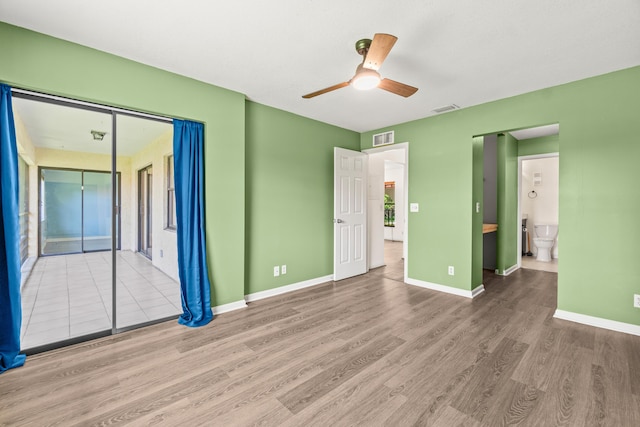 3 Via De Casas Sur Unit 204, Boynton Beach, FL 33426 - unfurnished bedroom with wood finished floors, baseboards, ensuite bathroom, and ceiling fan