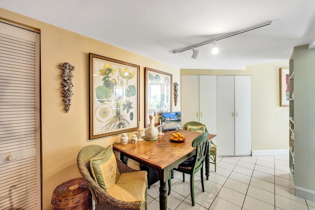 3701 S Flagler Dr Unit A101, West Palm Beach, FL 33405 - dining room featuring rail lighting, light tile patterned floors, and baseboards