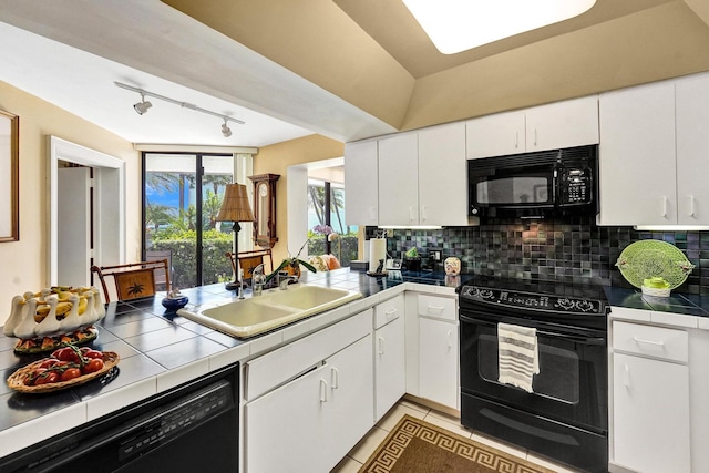 3701 S Flagler Dr Unit A101, West Palm Beach, FL 33405 - kitchen with black appliances, tile countertops, a sink, and decorative backsplash