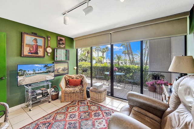 3701 S Flagler Dr Unit A101, West Palm Beach, FL 33405 - tiled living room featuring rail lighting, plenty of natural light, and baseboards