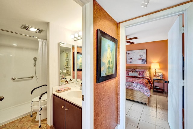 3701 S Flagler Dr Unit A101, West Palm Beach, FL 33405 - bathroom with tile patterned floors, connected bathroom, vanity, a shower with curtain, and ceiling fan