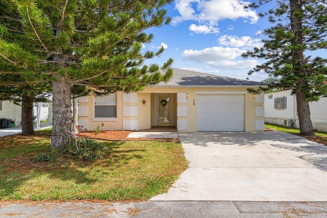 view of front of home with stucco siding, a garage, concrete driveway, and roof with shingles