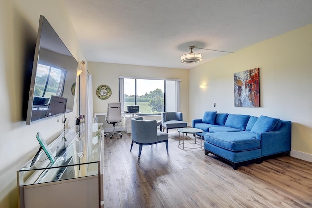 830 Greensward Ct Unit 107-H, Delray Beach, FL 33445 - living area featuring plenty of natural light, wood finished floors, an office area, and baseboards