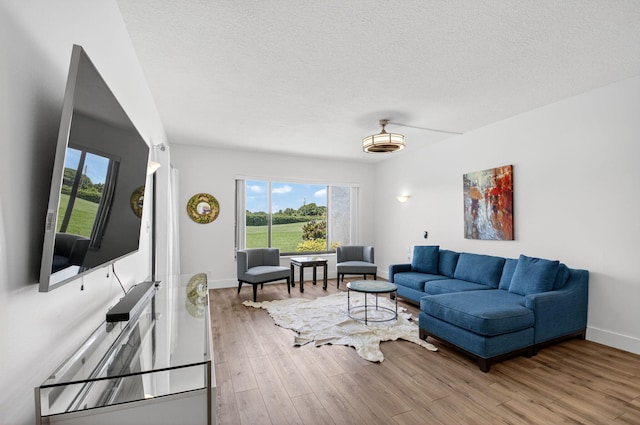830 Greensward Ct Unit 107-H, Delray Beach, FL 33445 - living area with wood finished floors and a textured ceiling