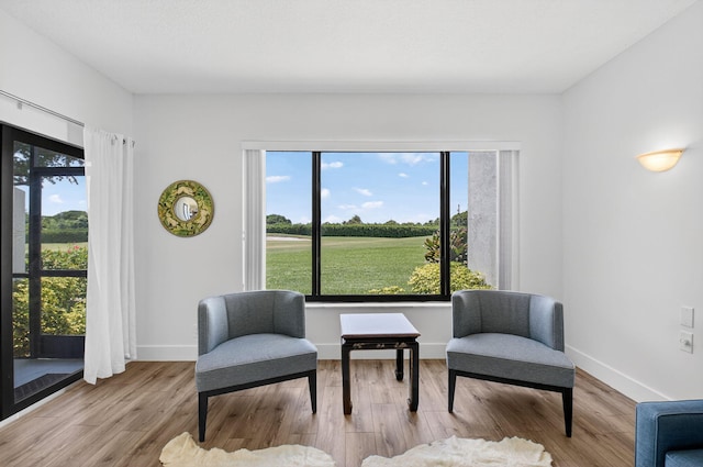 830 Greensward Ct Unit 107-H, Delray Beach, FL 33445 - sitting room featuring healthy amount of natural light and wood finished floors