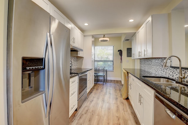 830 Greensward Ct Unit 107-H, Delray Beach, FL 33445 - kitchen featuring appliances with stainless steel finishes, a sink, under cabinet range hood, dark stone countertops, and backsplash