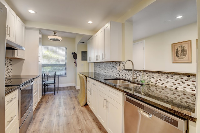 830 Greensward Ct Unit 107-H, Delray Beach, FL 33445 - kitchen featuring a sink, stainless steel dishwasher, dark stone counters, under cabinet range hood, and white cabinets