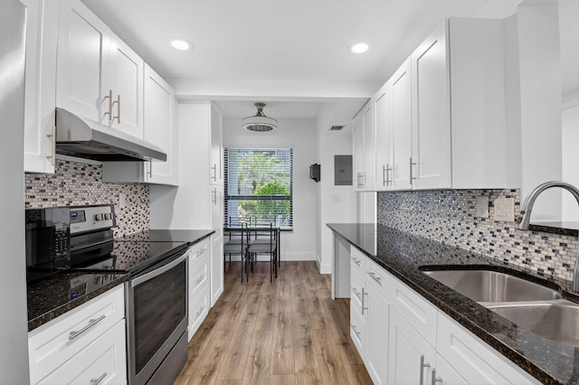 830 Greensward Ct Unit 107-H, Delray Beach, FL 33445 - kitchen featuring under cabinet range hood, stainless steel range with electric stovetop, white cabinetry, light wood-type flooring, and dark stone countertops
