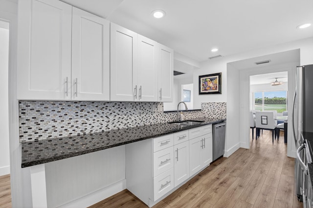 830 Greensward Ct Unit 107-H, Delray Beach, FL 33445 - kitchen featuring appliances with stainless steel finishes, white cabinetry, dark stone counters, light wood-style floors, and recessed lighting