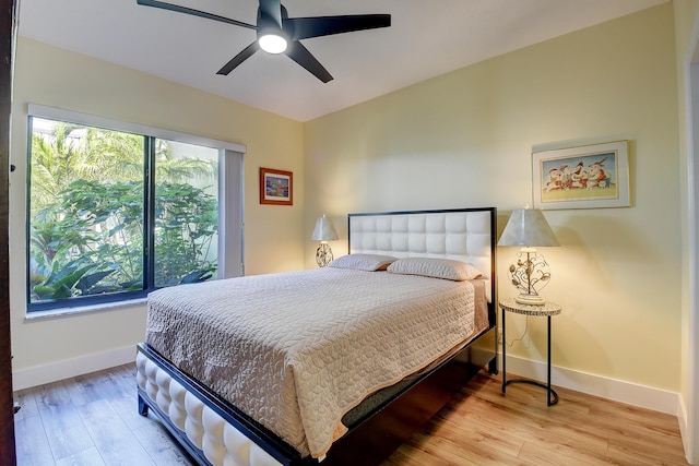 830 Greensward Ct Unit 107-H, Delray Beach, FL 33445 - bedroom featuring baseboards, wood-type flooring, and a ceiling fan