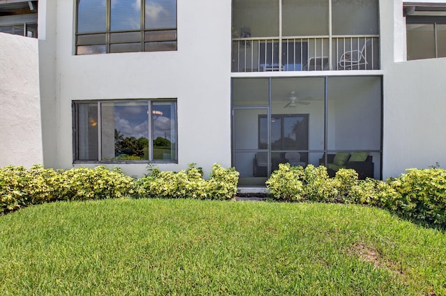 830 Greensward Ct Unit 107-H, Delray Beach, FL 33445 - back of house with stucco siding, a lawn, and ceiling fan