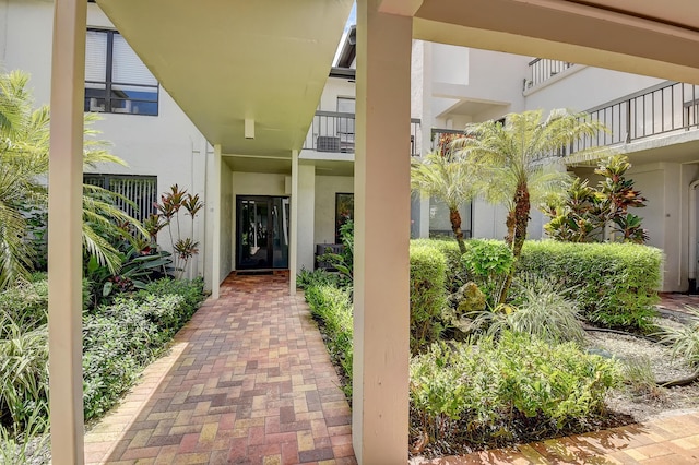 830 Greensward Ct Unit 107-H, Delray Beach, FL 33445 - view of exterior entry featuring stucco siding