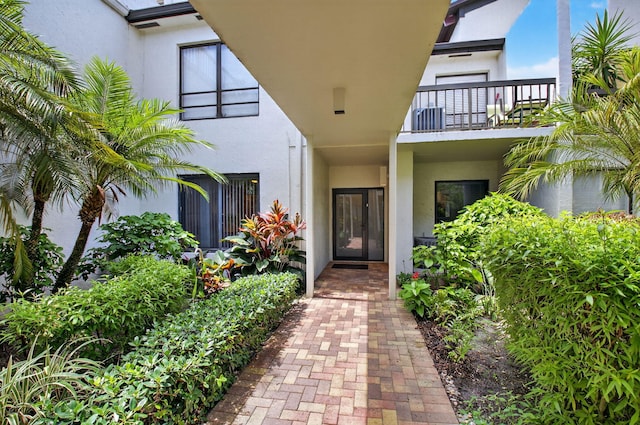 830 Greensward Ct Unit 107-H, Delray Beach, FL 33445 - doorway to property with stucco siding and a balcony