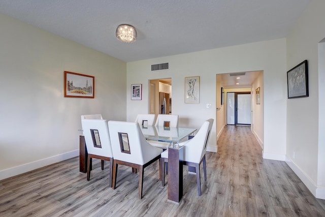 830 Greensward Ct Unit 107-H, Delray Beach, FL 33445 - dining space with light wood-style flooring and baseboards