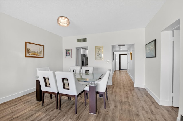 830 Greensward Ct Unit 107-H, Delray Beach, FL 33445 - dining space with light wood-style flooring and baseboards