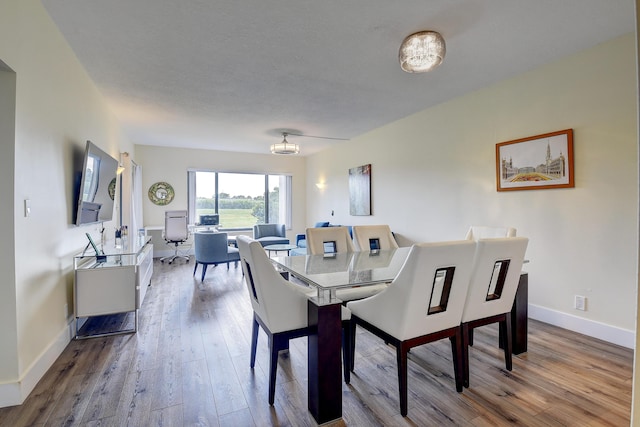 830 Greensward Ct Unit 107-H, Delray Beach, FL 33445 - dining space featuring wood finished floors, baseboards, and a chandelier