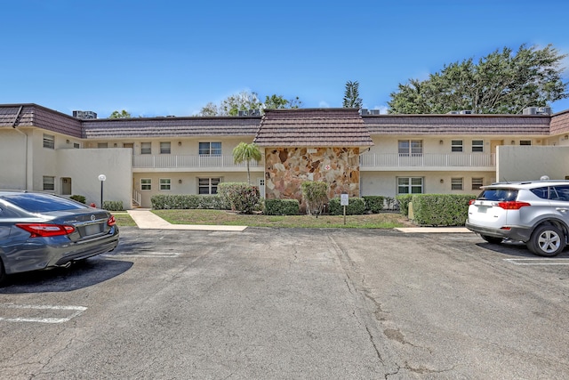 12003 Poinciana Blvd Unit 102, Royal Palm Beach, FL 33411 - view of property featuring uncovered parking