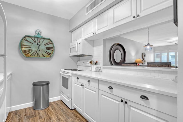12003 Poinciana Blvd Unit 102, Royal Palm Beach, FL 33411 - kitchen with white appliances, dark wood finished floors, white cabinetry, and hanging light fixtures