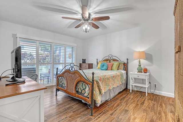 12003 Poinciana Blvd Unit 102, Royal Palm Beach, FL 33411 - bedroom featuring light wood finished floors, access to exterior, and ceiling fan