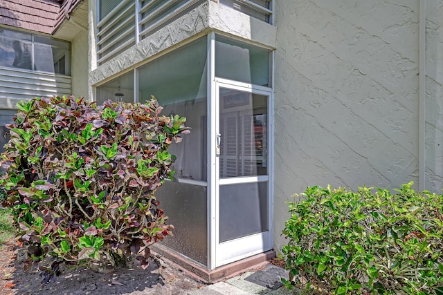 12003 Poinciana Blvd Unit 102, Royal Palm Beach, FL 33411 - doorway to property with stucco siding
