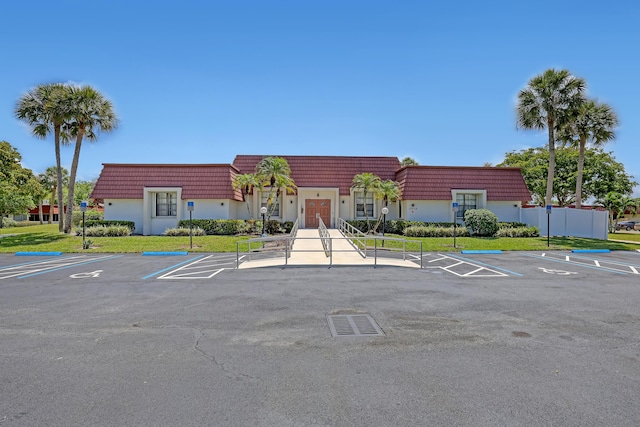 12003 Poinciana Blvd Unit 102, Royal Palm Beach, FL 33411 - view of building exterior with uncovered parking